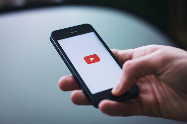 a smartphone starting a youtube video