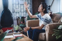 Asian man lifting his hand in worship