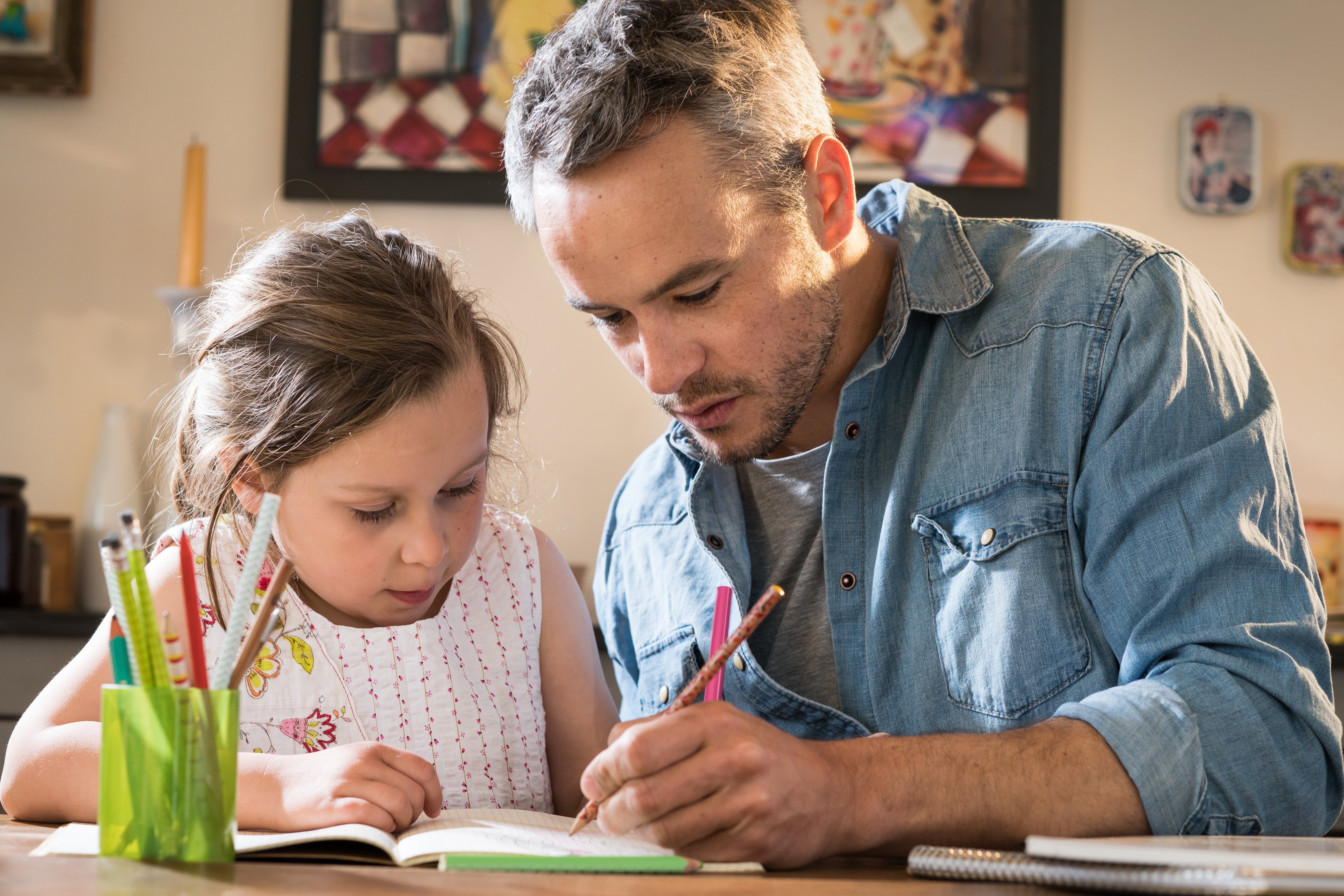 Dad teaching English to his daughter