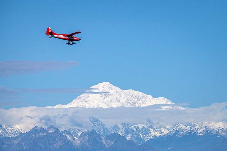 Bush plane over snowy Alaskan mountains