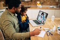 Father and daughter on telemedicine call