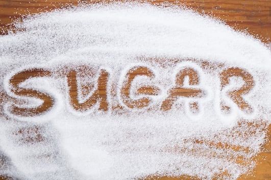 "sugar" spelled in sugar on a table