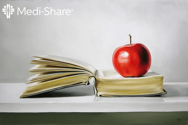 Apple sitting on open Bible
