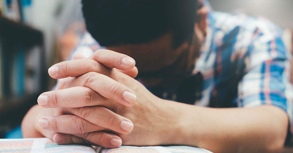 Man Praying with Bible