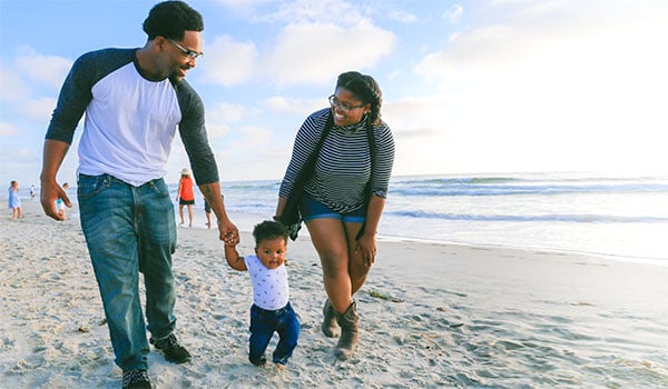 black family walking on the beach