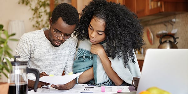 couple budgeting at kitchen table