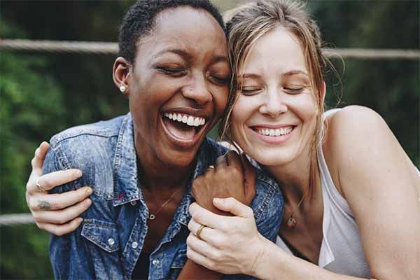 friends hugging and smiling