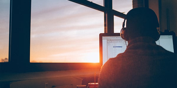 man at desk during sunrise