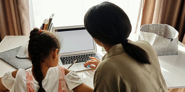 mom and daughter doing school