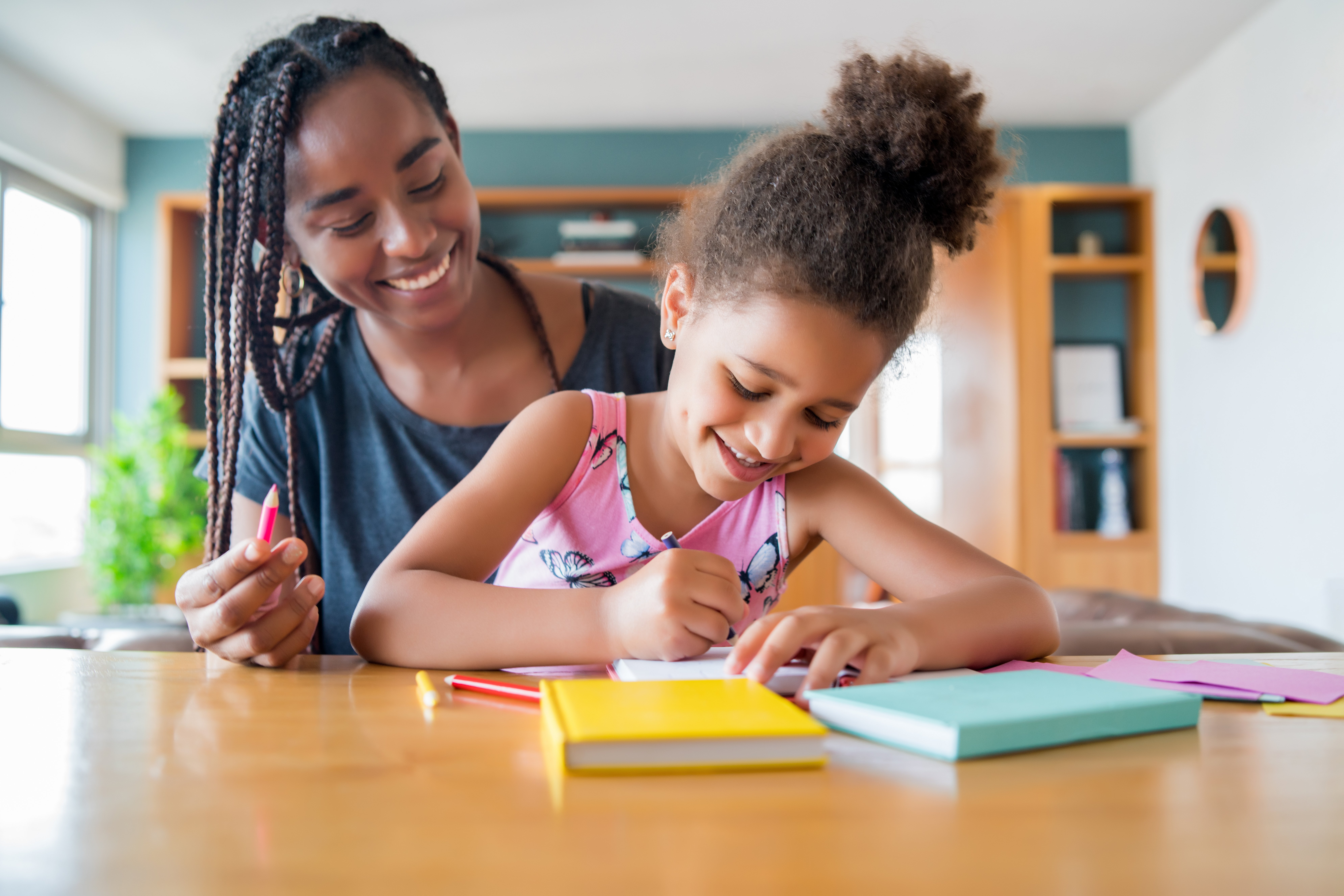A mom doing work with her daughter