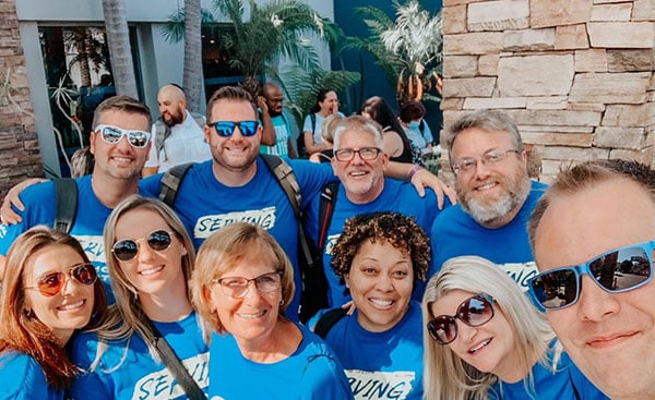 Group of Christian Care Ministry employees smiling in matching shirts