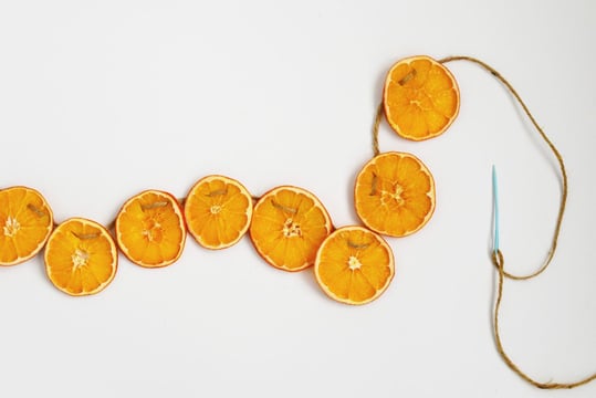 Dried orange slices threaded onto twine to make a DIY holiday garland