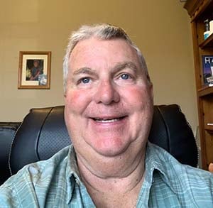 Medi-Share member Jim Sparling smiling in a black leather chair