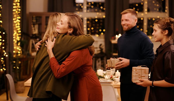 Family hugging giving gifts