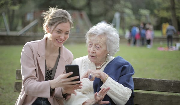 Granddaughter showing grandma image on phone