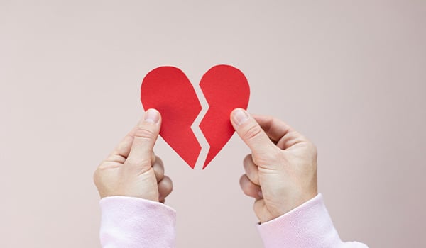 Hands holding broken heart