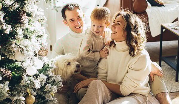 Happy family by christmas tree