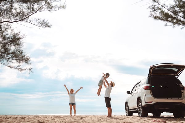 Family at beach, unpacking their SUV