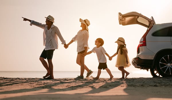 A family on the beach holding hands