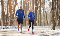 Couple running together in cold weather