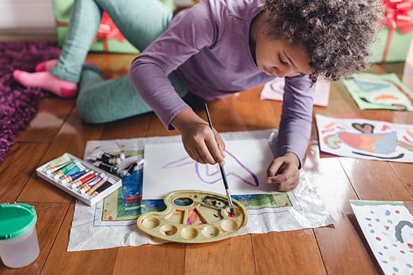 Girl painting on the floor