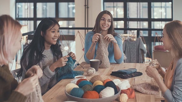 Friends knitting together