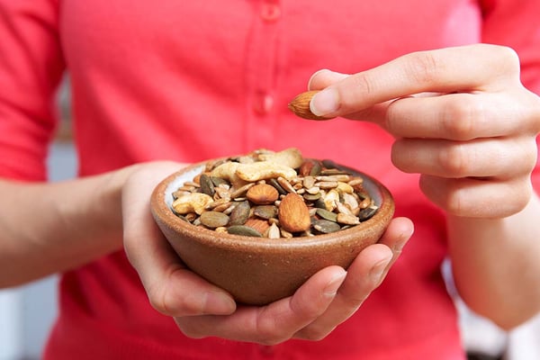 Woman eating nuts and seeds