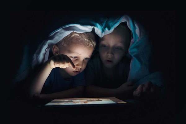 Kids watching tablet at night