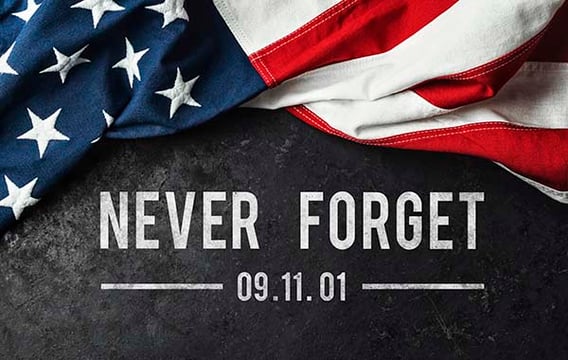 American flag draped above the words Never Forget 09.11.01 on a dark slate background