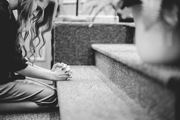 Woman kneeling in church