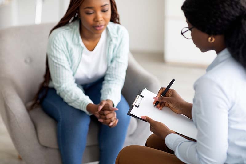 Woman sitting with counselor