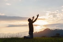 Man raising hands in prayer