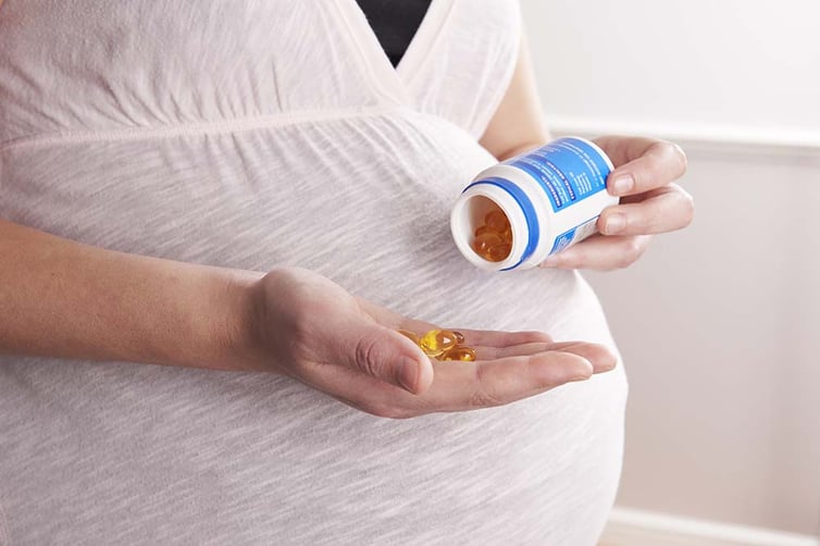 Woman taking prenatal vitamins