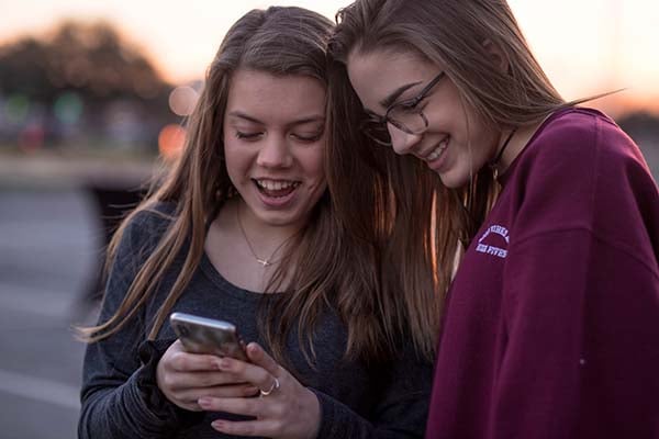 Teens looking at a phone