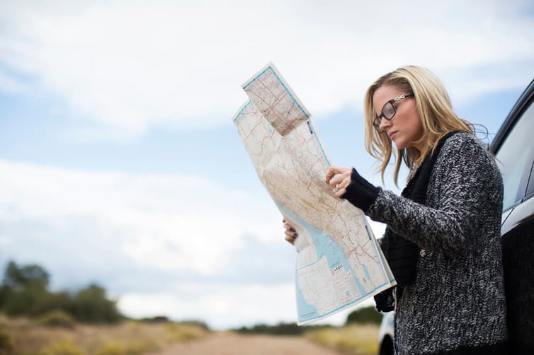 Woman trying to find her way on a map