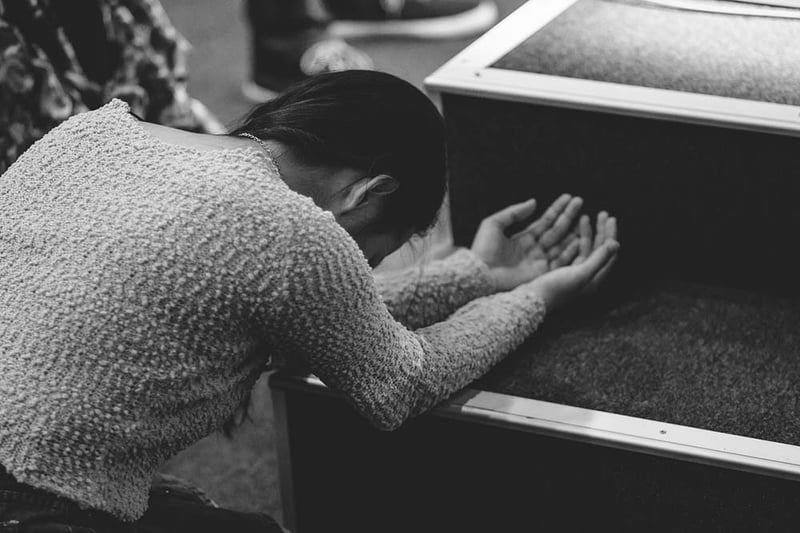 Woman kneeling in prayer
