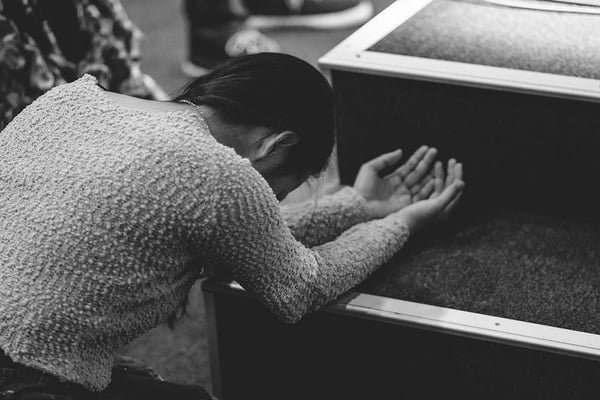 Woman bowing in worship