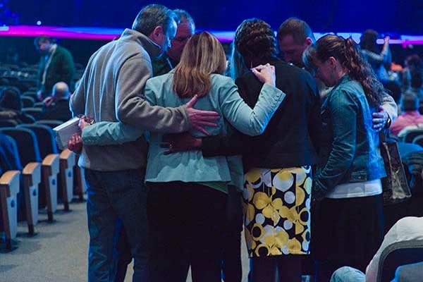 Group huddling in prayer