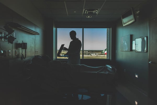 Doctor talking to patient in hospital bed