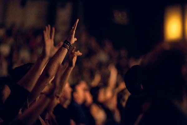 Crowd raising their hands in worship