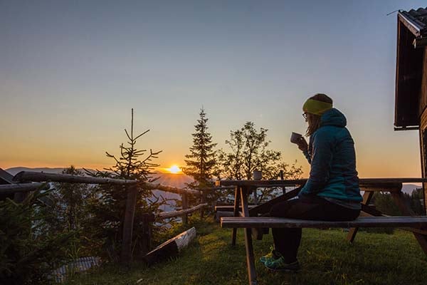 Woman sitting on porch looking at the horizon