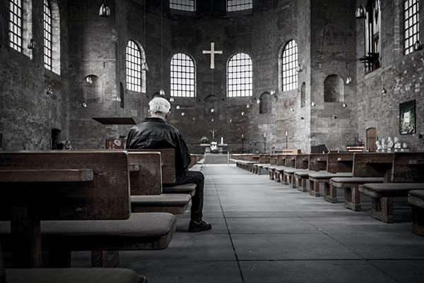 Man in a church praying