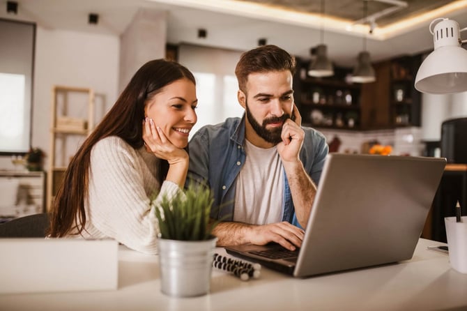 A couple reviewing healthcare costs on a laptop