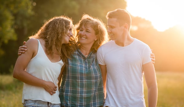 Mom hugging adult children
