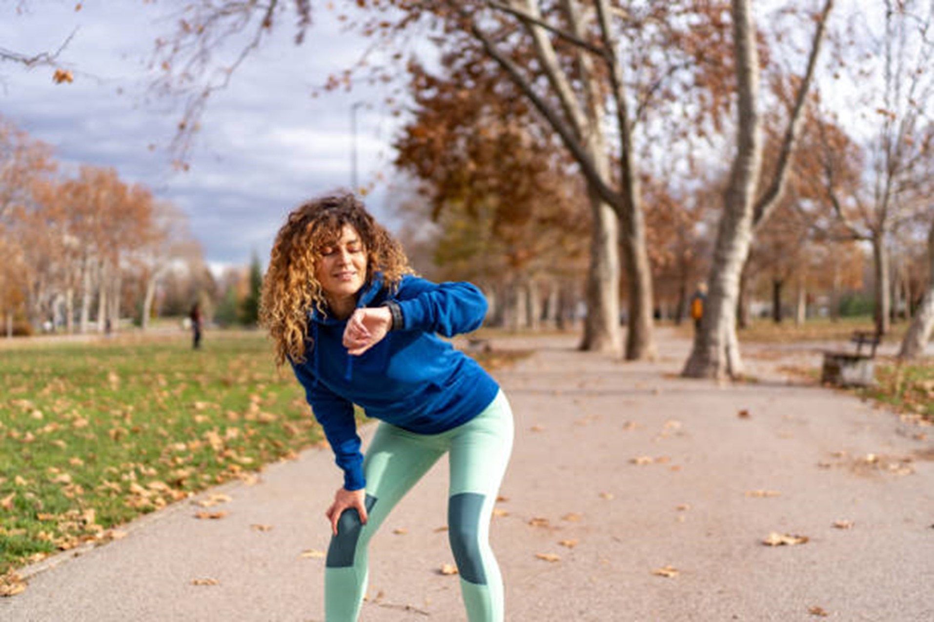 woman checking her fitness tracker while exercising