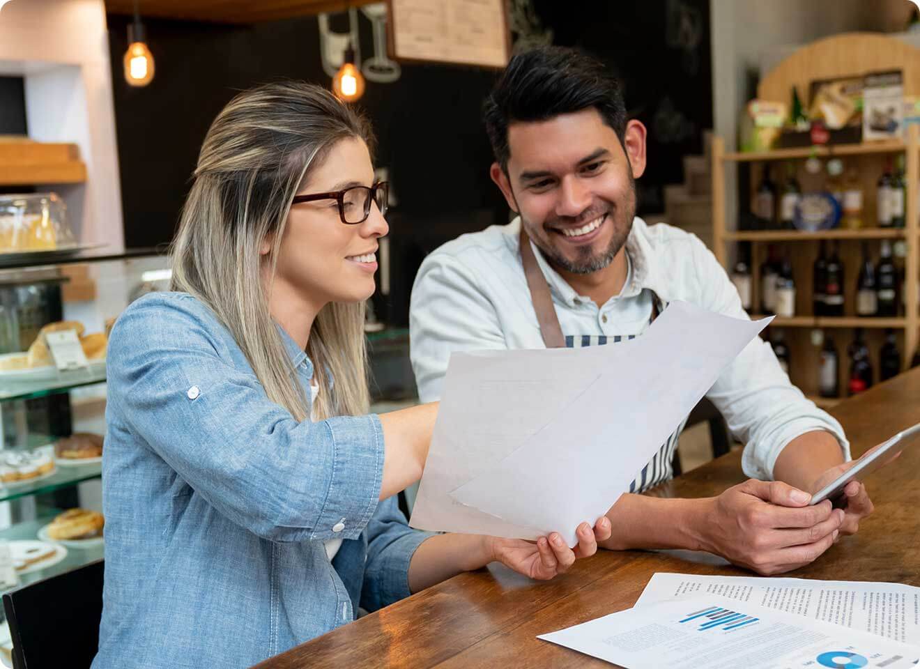 Self Employed couple looking through Medi-Share perks, savings and how to join.