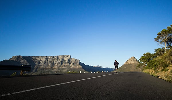 Runner on the road with mountains