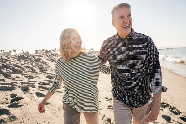 Medi-Share 65+ couple walking the beach
