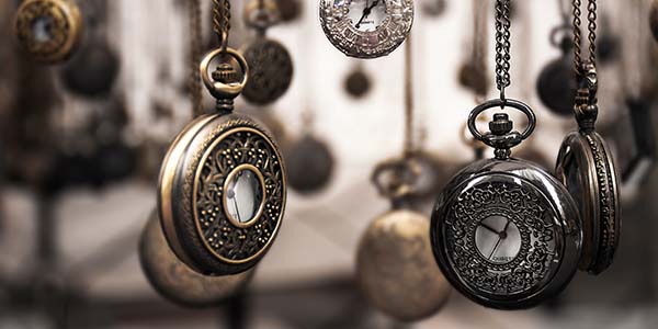 a group of pocket watches hanging up