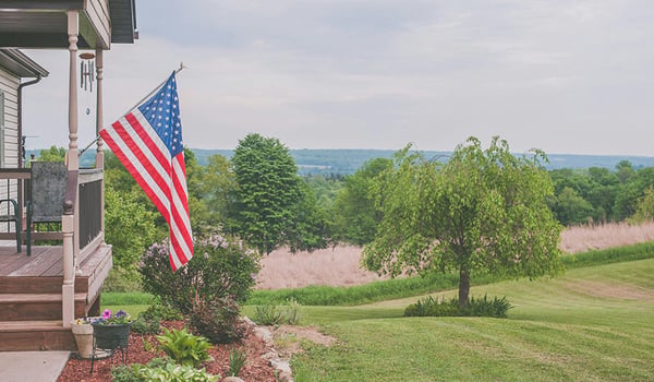 american flag hanging on front porch